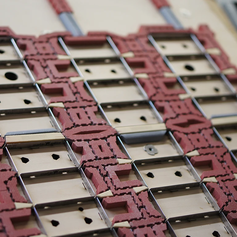 Close-up view of a die cutting machine's intricate network of blades and plates, showcasing the precise and efficient blanking technology used to swiftly convert full sheets into individual cartons.