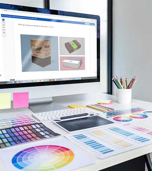 A graphic design workstation with an open packaging artwork file on the screen, surrounded by color swatches and design tools, embodying the strategic marketing approach through packaging design.