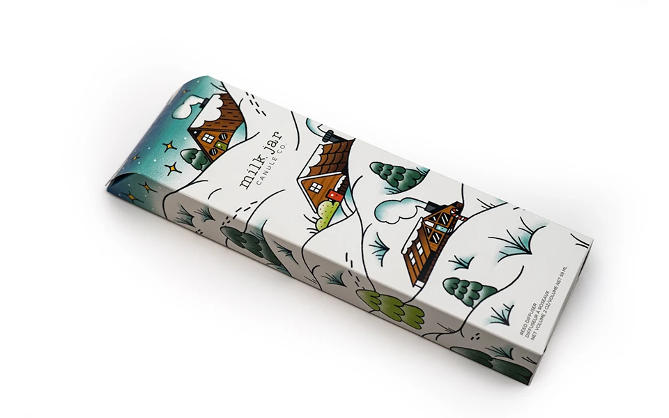 Whimsical Milk Jar candle box with a countryside illustration, representing Ingersoll Paper Box's custom graphic design service.