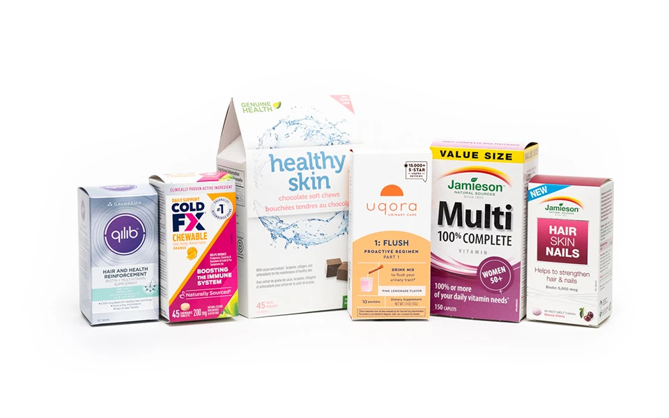 Assorted health product boxes including Genuine Health supplements and Cold-FX, showcasing Ingersoll Paper Box's diverse packaging capabilities.