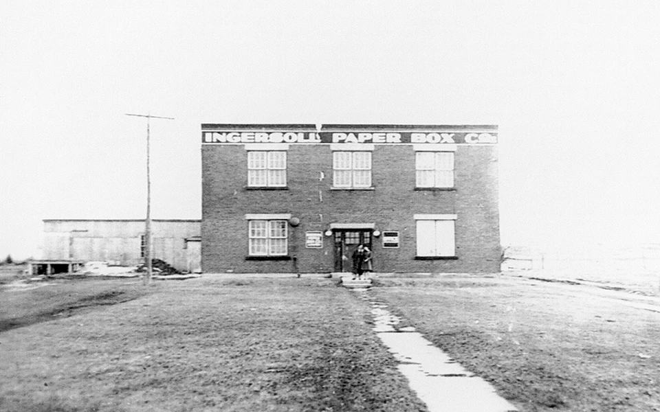 A black and white archival photo of the original Ingersoll Cone and Paper Box factory, marking the humble beginnings of the company that would become a trusted name in the paper box industry.